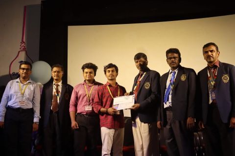 Jaikiran receiving winner honors and certificate from dignitaries during college technical award ceremony
